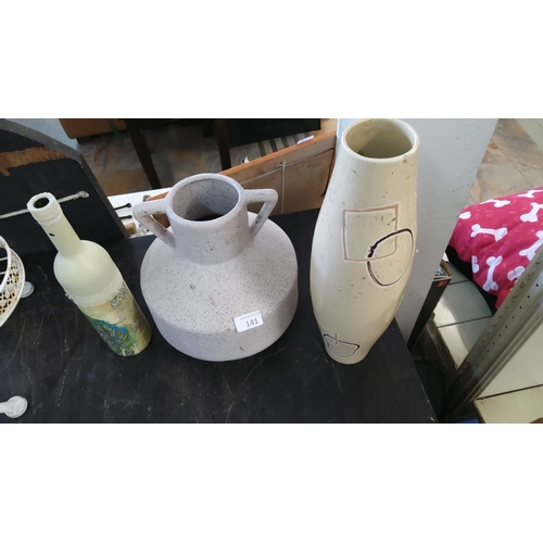 141 - Three decorative vases including one embellished bottle, a speckled two-handled jug, and a tall vase... 