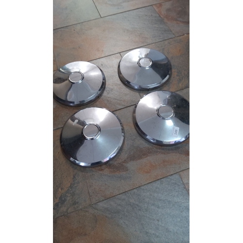 149 - Set of four vintage chrome-plated hubcaps, classic round design with central caps.
