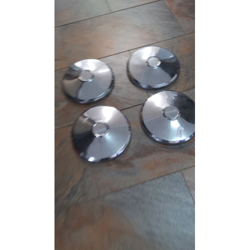 149 - Set of four vintage chrome-plated hubcaps, classic round design with central caps.