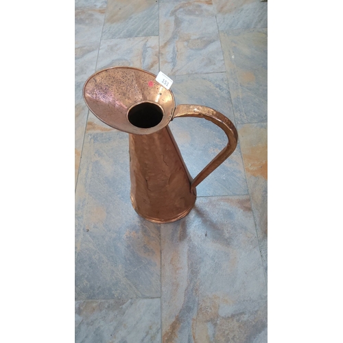 151 - Handmade hammered copper pitcher with a curved handle and spout. A unique decorative piece with a ru... 