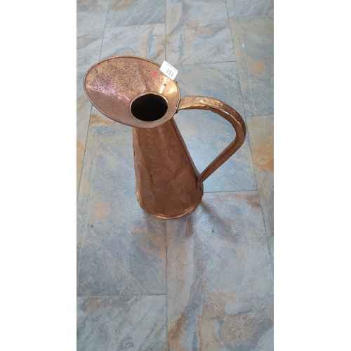 151 - Handmade hammered copper pitcher with a curved handle and spout. A unique decorative piece with a ru... 