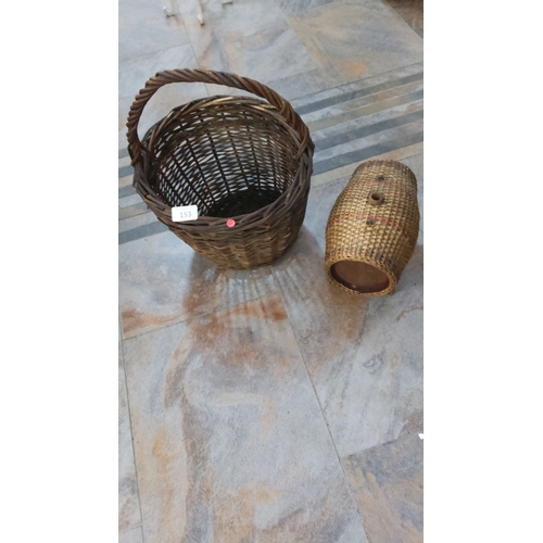 153 - Pair of vintage wicker baskets, one with a handle. The larger basket features an open-weave design, ... 