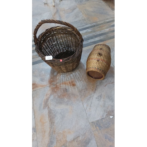 153 - Pair of vintage wicker baskets, one with a handle. The larger basket features an open-weave design, ... 