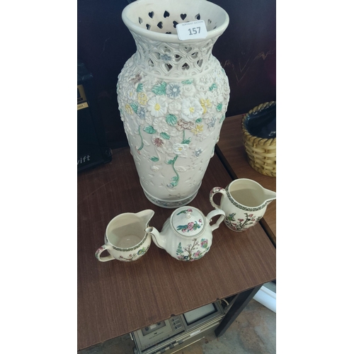 157 - Hand-painted floral ceramic vase with intricate cut-out design. Accompanied by three pieces of flora... 