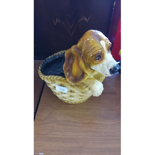 158 - Ceramic beagle dog peeking over a basket edge. Hand-painted in brown and white tones.