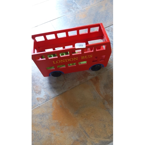 159 - Red wooden toy London bus with yellow lettering and black wheels. Designed with open-windows and a s... 