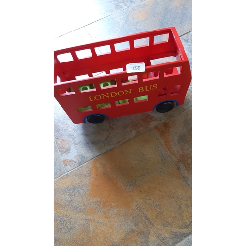 159 - Red wooden toy London bus with yellow lettering and black wheels. Designed with open-windows and a s... 