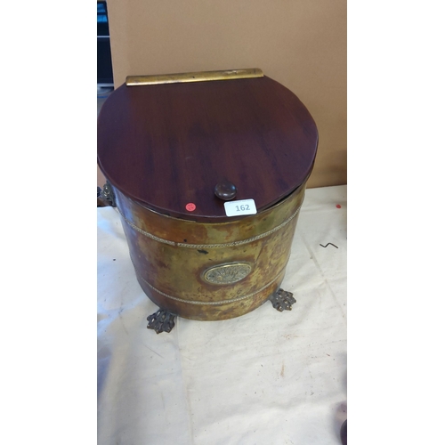162 - Antique Victorian brass and wood coal scuttle, adorned with ornate lion paw feet and embossed medall... 