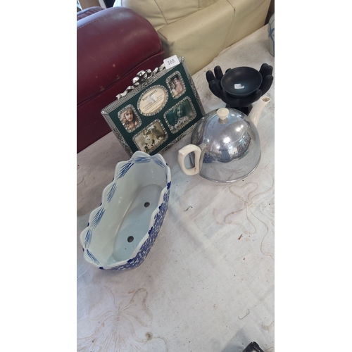 169 - Includes a green multi-photo frame, blue and white ceramic planter, a metallic teapot with ceramic h... 