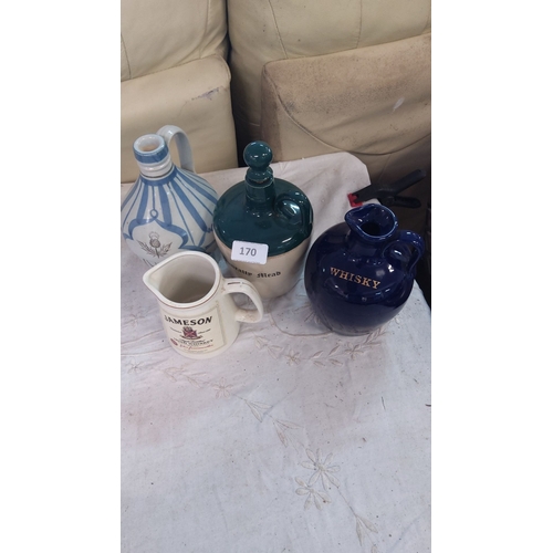 170 - Set of four ceramic whisky jugs, each with unique designs and markings. Various shapes and sizes.