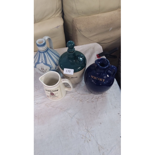 170 - Set of four ceramic whisky jugs, each with unique designs and markings. Various shapes and sizes.