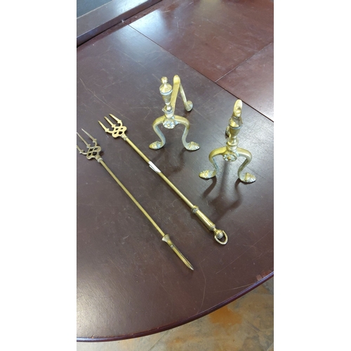 177 - Pair of brass andirons with decorative finials and two matching toasting forks