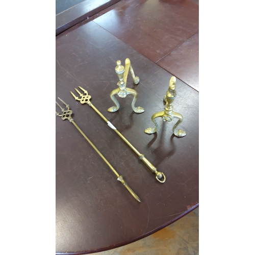 177 - Pair of brass andirons with decorative finials and two matching toasting forks