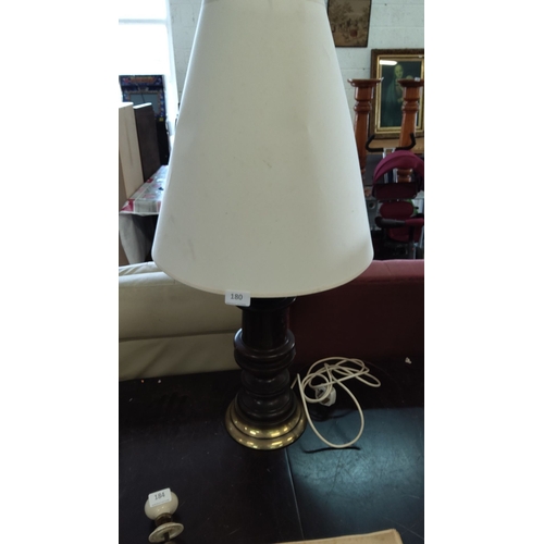 180 - Vintage table lamp with a dark wooden turned base and brass accents, accompanied by a large cream-co... 