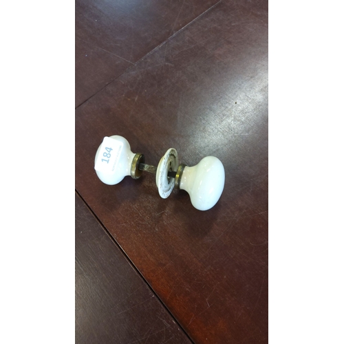 184 - White porcelain door knobs with brass fittings, dated 1894.