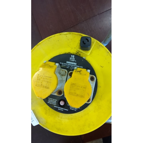189 - Yellow and black 110 extension cord reel with dual socket outlets. Includes a sturdy carrying handle... 
