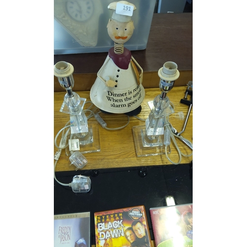 191 - Set of two clear glass table lamps with electrical cords, a decorative chef figurine
