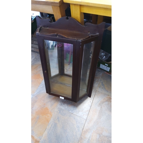 197 - Vintage dark wood wall-mounted display cabinet with glazed front and sides, featuring a decorative t... 