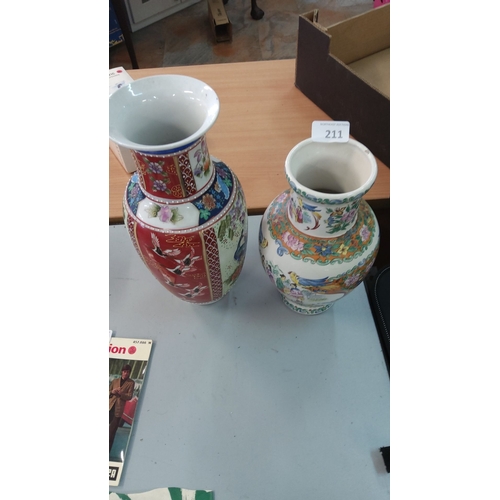 211 - Pair of Chinese porcelain vases. One vase has vivid red panels depicting cranes and floral motifs, w... 