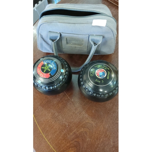 225 - Set of two Thomas Taylor lawn bowls, size 3, includes a carrying case.