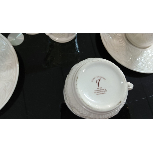 228 - Set of four Belleek Serenity Collection tea cups with matching saucers, featuring embossed floral de... 