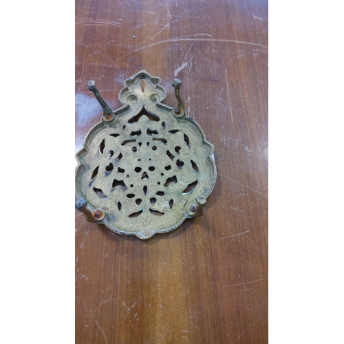 229 - Victorian brass trivet with intricate filigree design. Elevated on 4 legs with ornate detailing.