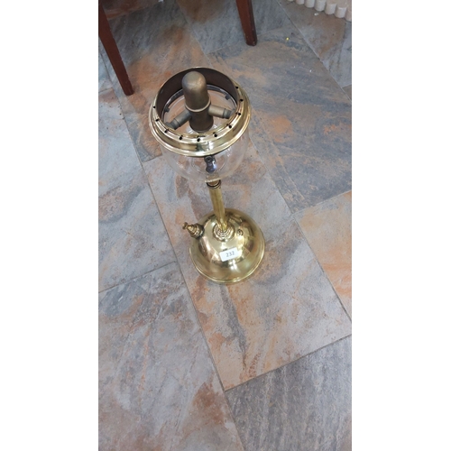 232 - Antique brass oil lamp, featuring a glass globe and adjustable burner mechanism. Victorian period de... 