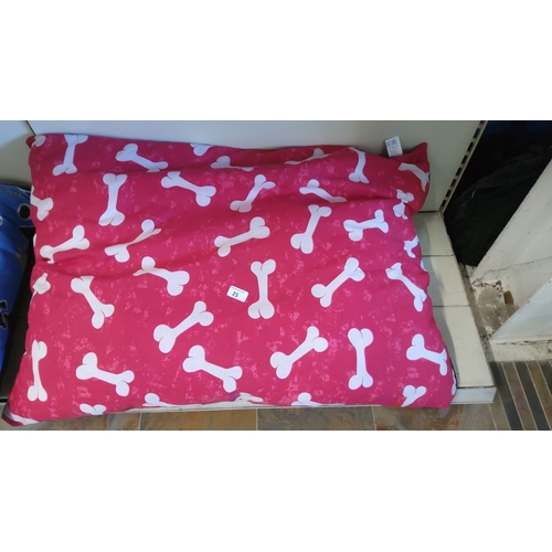 25 - Large rectangular dog bed, pink with a white bone pattern.