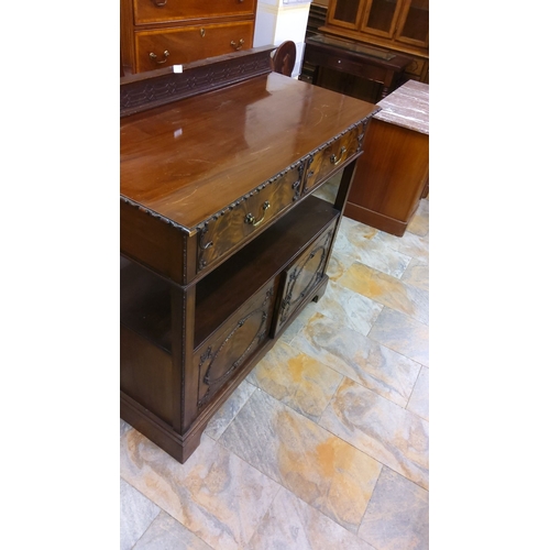 258 - Edwardian mahogany sideboard with intricate carvings. Features two upper drawers with brass handles,... 
