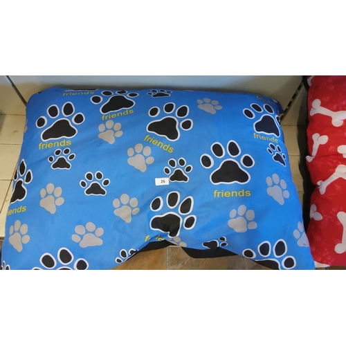 26 - Blue pet pillow with black and grey paw prints, featuring the word 