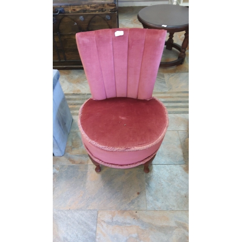 268 - Mid-Century Modern pink velvet chair with scalloped back and round seat. Features a wooden base with... 