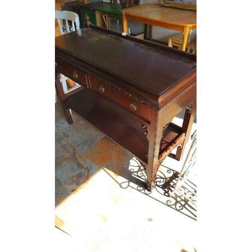 275 - Victorian mahogany console table with intricate brass drawer pulls and a lower shelf. Features detai... 