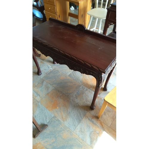 278 - Vintage mahogany side table with intricate carved details, likely from the early 20th century. Featu... 