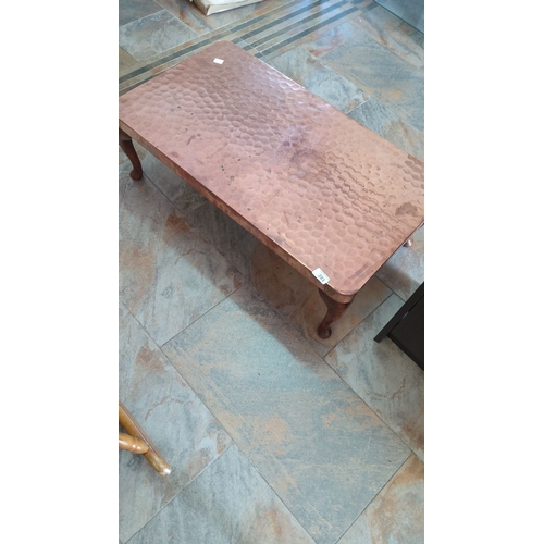 281 - Hand-hammered low copper coffee table with wooden cabriole legs. Likely mid-20th century.