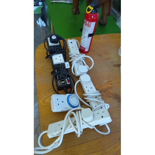 308 - Includes four power strips and one fire extinguisher. Assortment of 3 white extension leads and 1 bl... 