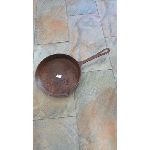 53 - Vintage cast iron skillet with a pour spout, featuring a long handle and a rustic patina.