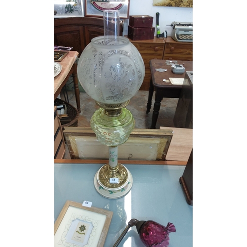 58 - Victorian glass oil lamp with etched floral globe and green glass font, featuring a brass base with ... 