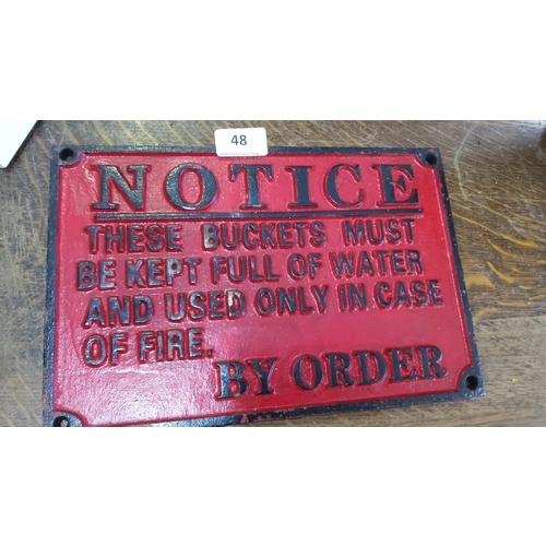 48 - Cast iron fire notice sign in red and black.