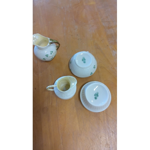 11 - Set of four Belleek Irish porcelain pieces, including two creamers and two bowls, featuring the trad... 