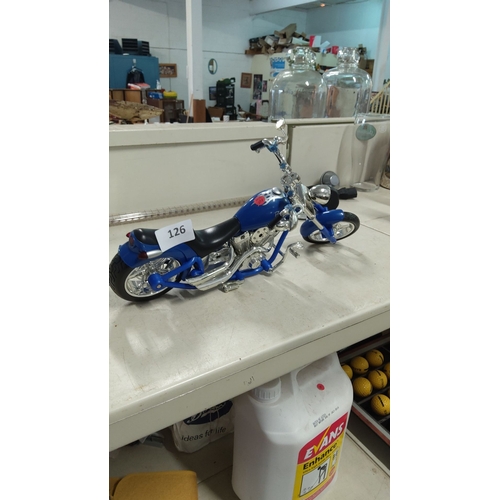 126 - Miniature blue motorbike model with detailed chrome accents and a sleek black seat.