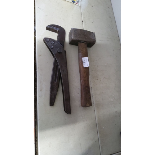 131 - Vintage adjustable pipe wrench and a heavy-duty hammer with a wooden handle.