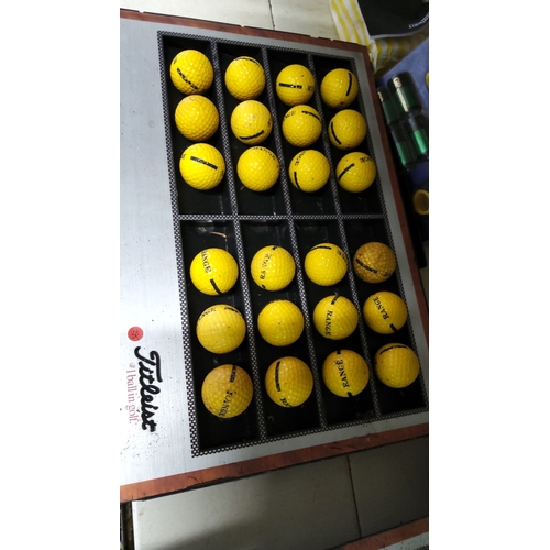 135 - Set of 24 yellow range golf balls arranged in a metal display tray.