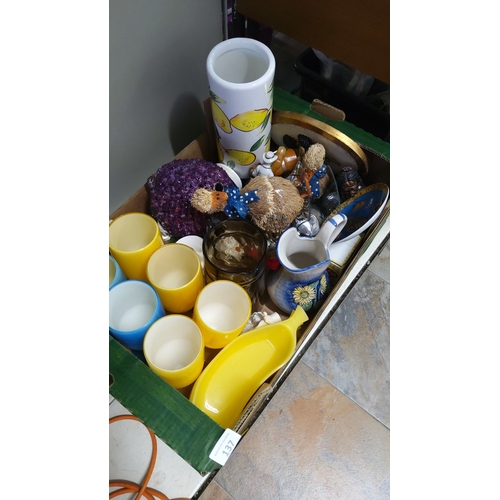 137 - Mixed lot containing assorted ceramic mugs, decorative jug, yellow glassware, ceramic lemon-themed v... 