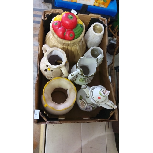 141 - Mixed lot of ceramic and porcelain items including pitchers, teapot, vase, and lidded jar with fruit... 