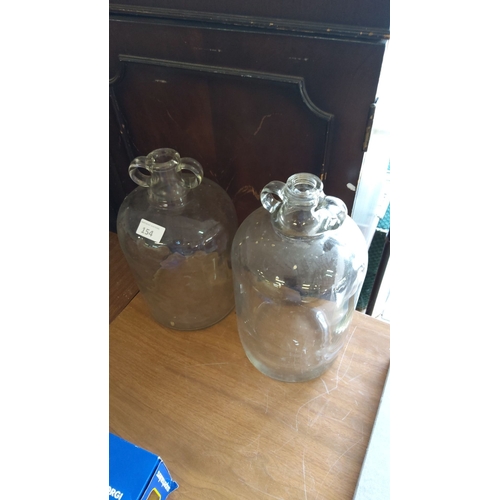 154 - Pair of vintage large clear glass demijohn bottles with twin side handles.