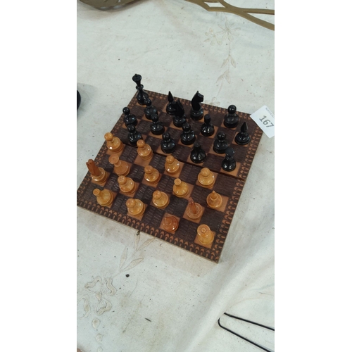 167 - Hand-carved wooden travel chess set featuring a detailed, patterned board and black and natural wood... 