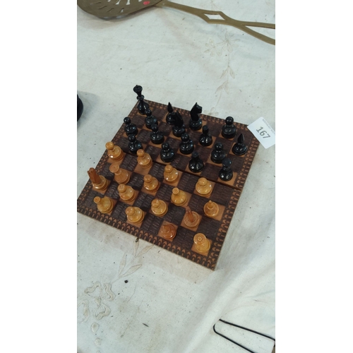 167 - Hand-carved wooden travel chess set featuring a detailed, patterned board and black and natural wood... 