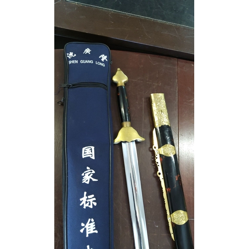 172 - Shen Guang Long sword with gold and black handle, ornate gold sheath, and blue carrying case with Ch... 