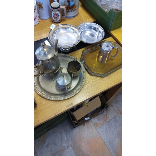 186 - Vintage silver-plated tea set with tray, includes teapot, sugar bowl, creamer, two trays, and additi... 