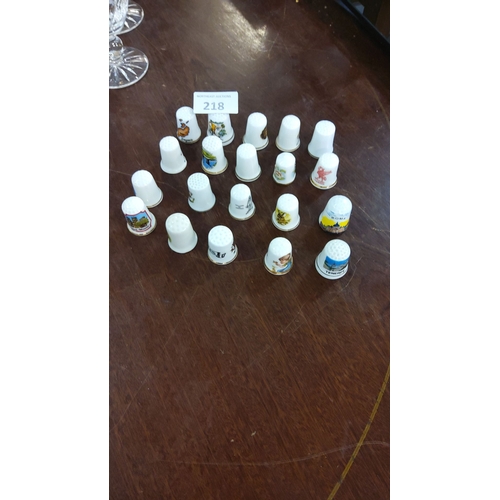 218 - Set of 20 decorative porcelain thimbles featuring various tourist landmarks and animal motifs.